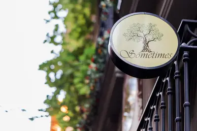 a sign for a store with a tree on it at Sometimes Hotel Taksim in Istanbul