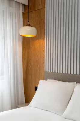 a bedroom with a white bed and a lamp at Pia Global - Nevizade in Istanbul
