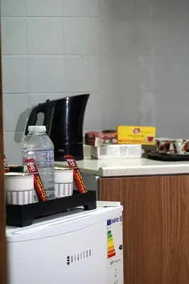 a bottle of water sitting on top of a refrigerator at Emir City Hotel in Bursa