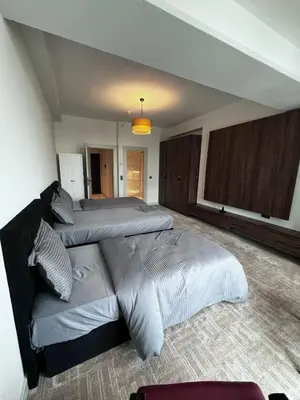 a bedroom with two beds and a couch at Luxury family-balcony apt in Istanbul