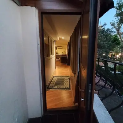 a door to a balcony with a view of a room at Coskun apt in Istanbul