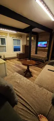 a living room with a table and a tv at Coskun apt in Istanbul