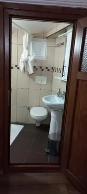 a bathroom with a sink and a toilet and a mirror at Coskun apt in Istanbul