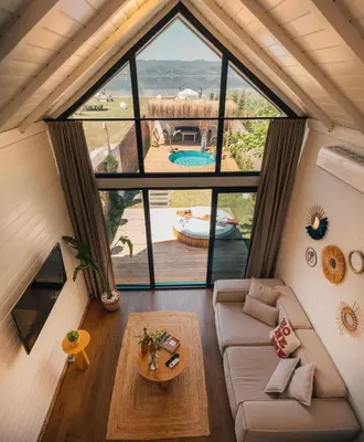 a room with a couch and a large window at Boheme Bungalow Sapanca in Sapanca