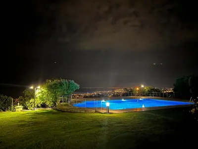 a night view of a swimming pool in a park at Luxury Mansion Amazing View, Hidden Garden in Celâliye