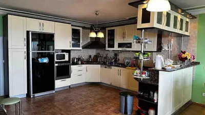 a kitchen with white cabinets and a black refrigerator at Luxury Mansion Amazing View, Hidden Garden in Celâliye