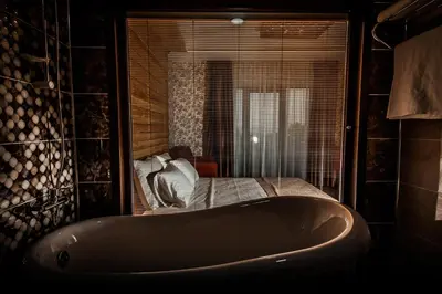 a bath tub in a room with a bed at My Green Otel in Sapanca