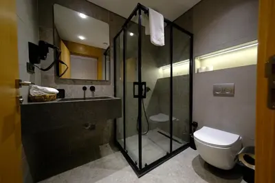 a bathroom with a shower and a toilet and a sink at Melekona House in Kartepe