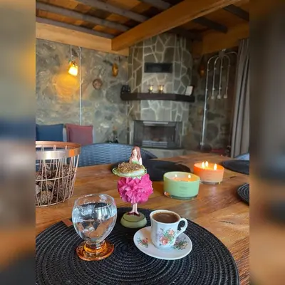 a table with a cup of coffee and a plate of food at Çalıkuşu Dağ Evi in Bursa
