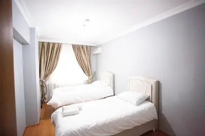 two white beds in a room with a window at Nomadia turkey in Istanbul