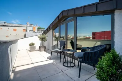 a patio with chairs and a table on a balcony at Sentire Hotels & Residences Taksim in Istanbul