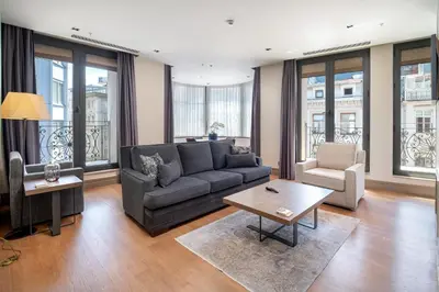 a living room with a couch and a table at Sentire Hotels & Residences Taksim in Istanbul
