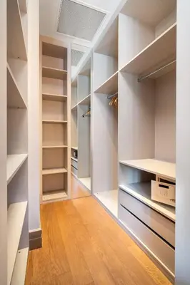 a walk in closet with white walls and wooden floors at Sentire Hotels & Residences Taksim in Istanbul