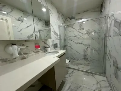 a bathroom with a shower and a sink and a mirror at Gold Suit in Istanbul