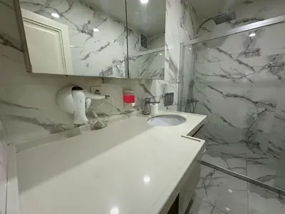 a white bathroom with a sink and a shower at Gold Suit in Istanbul