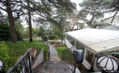 a stairway leading up to a house with a yard at Villa Büyükada I Private Pier & Seawater Pool in Istanbul