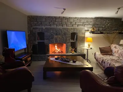 a living room with a fireplace and a couch at Villa Büyükada I Private Pier & Seawater Pool in Istanbul