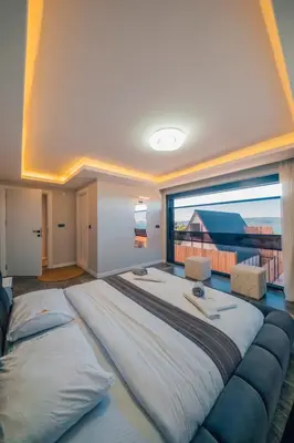 a large bed in a room with a large window at tetova in Sapanca