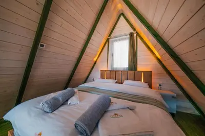 a bedroom with a large bed in a wooden house at tetova in Sapanca