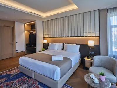 a hotel room with a large bed and a chair at Four-G Hotel Premium in Istanbul