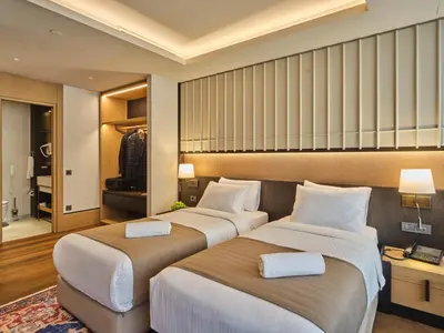 two beds in a hotel room with a bedroom at Four-G Hotel Premium in Istanbul