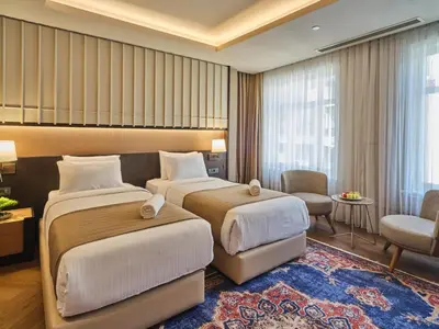 a hotel room with two beds and a living room at Four-G Hotel Premium in Istanbul
