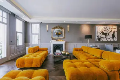 a living room with orange couches and a fireplace at Eva Bosphora Waterfront Living in Istanbul
