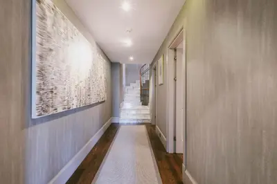 a hallway with stairs and a painting on the wall at Eva Bosphora Waterfront Living in Istanbul