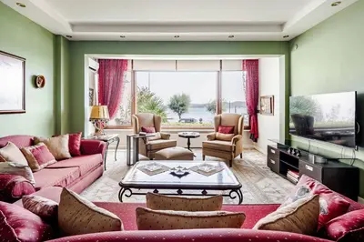 a living room with pink couches and a tv at Luxury Seaside Apartment with Bosphorus View in Sarıyer in Sarıyer