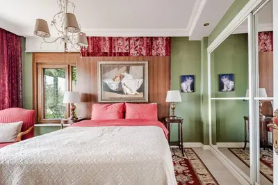 a bedroom with a bed with red and green walls at Luxury Seaside Apartment with Bosphorus View in Sarıyer in Sarıyer