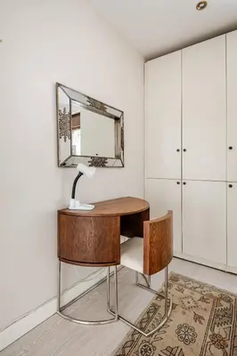 a desk with a lamp and a mirror on a wall at Luxury Seaside Apartment with Bosphorus View in Sarıyer in Sarıyer