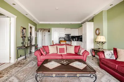 a living room with two red couches and a table at Luxury Seaside Apartment with Bosphorus View in Sarıyer in Sarıyer