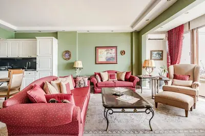 a living room with red furniture and green walls at Luxury Seaside Apartment with Bosphorus View in Sarıyer in Sarıyer