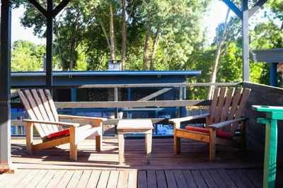 two wooden chairs and a table on a deck at Mints Hotel Ağva in Agva