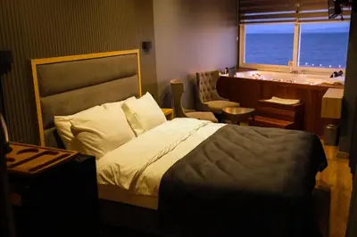 a bedroom with a bed and a desk and a window at iskele rum butik otel in Tekirdag