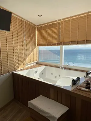 a bathroom with a tub and a sink and a window at iskele rum butik otel in Tekirdag
