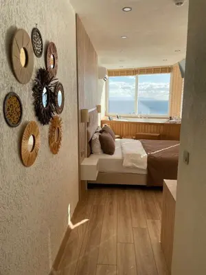 a bedroom with a bed and mirrors on the wall at iskele rum butik otel in Tekirdag