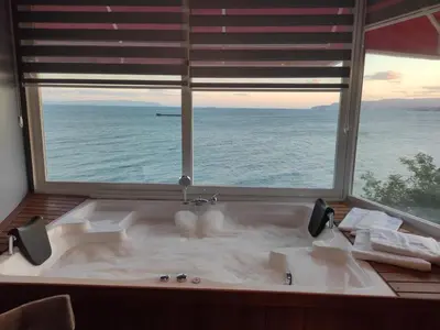 a large bath tub with a large window at iskele rum butik otel in Tekirdag