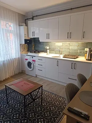 a kitchen with white cabinets and a washing machine at Üsküdar'da Tam Size Göre S in Istanbul
