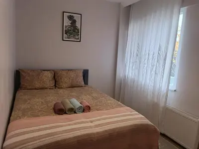 a bedroom with a bed with two pillows and a window at Üsküdar'da Tam Size Göre S in Istanbul