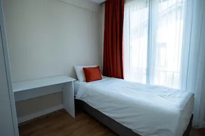 a small bedroom with a bed and a window at Sapanca Cayir Cimen Otel in Sapanca
