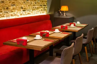 two tables in a restaurant with red napkins on them at Hotel Favori Nisantasi in Istanbul