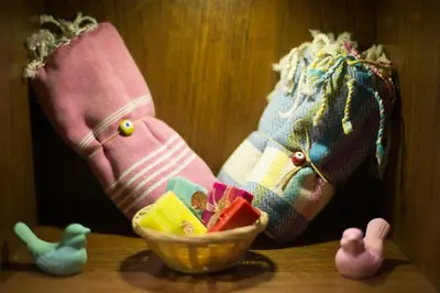 two pairs of socks on a table with a bowl of toys at Hotel Favori Nisantasi in Istanbul