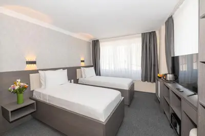 a hotel room with two beds and a television at Mays Otel in Istanbul