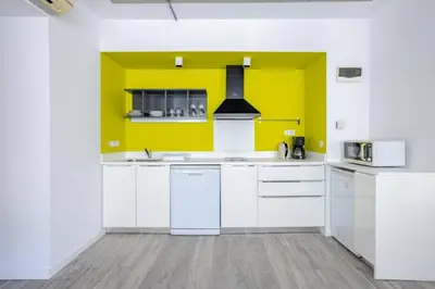 a kitchen with white appliances and a yellow wall at Cozy Coastal Hideaway with Bosphorus Breeze! #399 in Istanbul