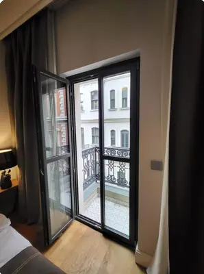 a bedroom with a view of a balcony at Taksim The 360 Hearth Of İstanbul 55-56 in Istanbul