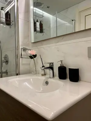 a bathroom sink with a vase with a flower on it at Taksim The 360 Hearth Of İstanbul 55-56 in Istanbul