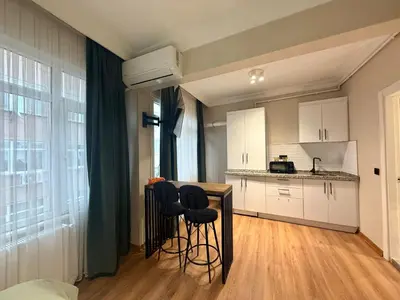 a kitchen with a counter and stools in a room at Serene aırbnb in Istanbul
