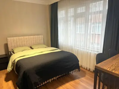 a bedroom with a bed and a large window at Serene aırbnb in Istanbul
