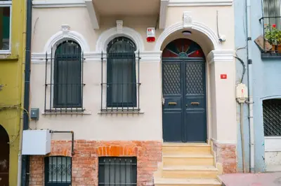 a building with a blue door and three windows at Casa Nozze 2 in Istanbul